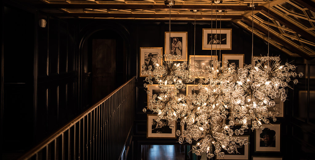 Stunning chandelier hangs above the upstairs balcony